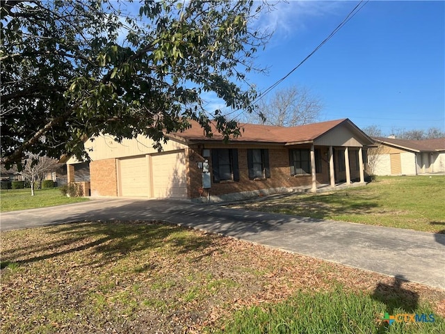 single story home featuring concrete driveway, brick siding, a front lawn, and an attached garage