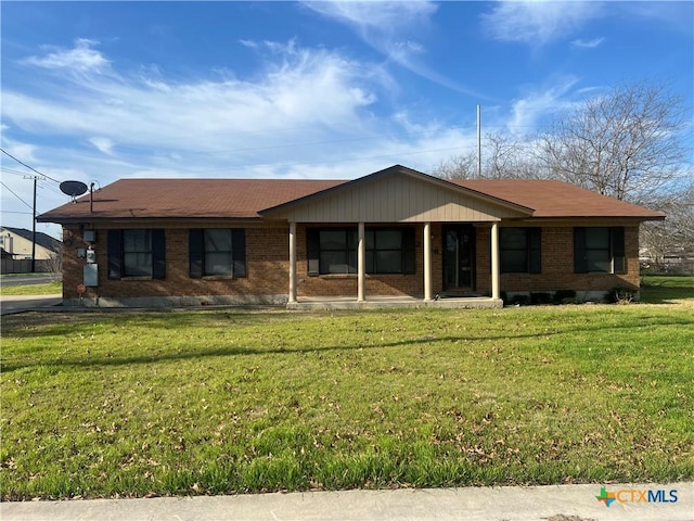 single story home featuring brick siding and a front yard