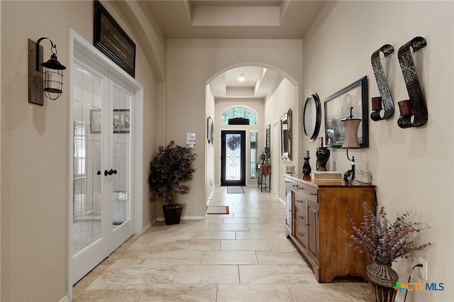 2194 Pioneer Pass, Seguin, TX 78155 - foyer featuring a tray ceiling, arched walkways, and french doors