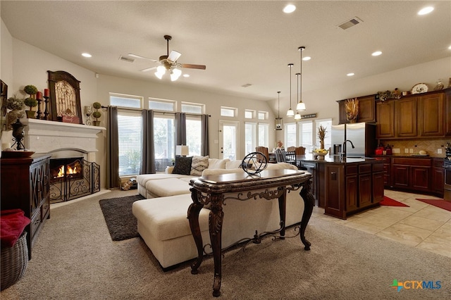 2194 Pioneer Pass, Seguin, TX 78155 - living area with recessed lighting, ceiling fan, a warm lit fireplace, light carpet, and light tile patterned floors