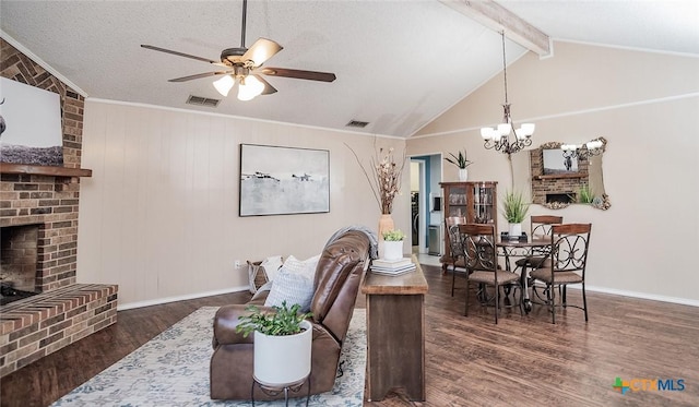 living area featuring lofted ceiling with beams, visible vents, a fireplace, wood finished floors, and ceiling fan with notable chandelier
