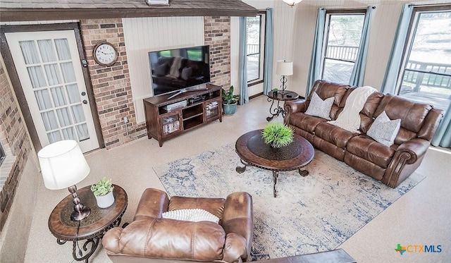 living room featuring brick wall