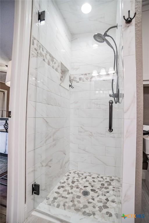 bathroom featuring a shower stall