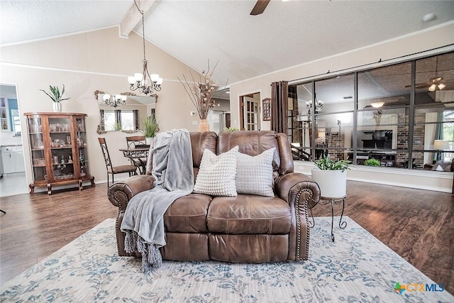 living room with ceiling fan with notable chandelier, lofted ceiling with beams, and wood finished floors