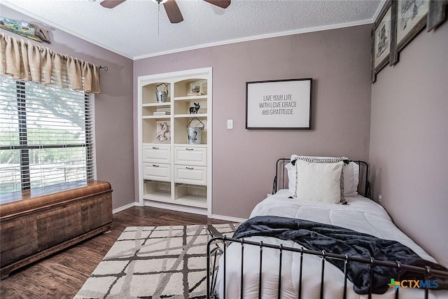bedroom featuring a textured ceiling, wood finished floors, ceiling fan, and ornamental molding