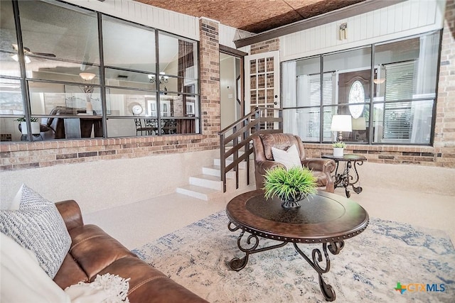 living area with brick wall