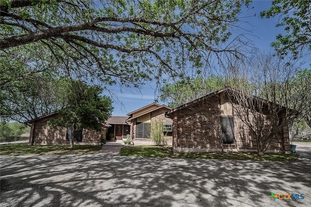 view of front of home featuring brick siding