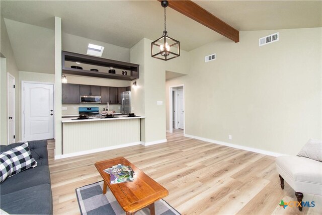 3918 Trinity Dr, Temple, TX 76504 - living room with light wood-style floors, beamed ceiling, a chandelier, baseboards, and high vaulted ceiling