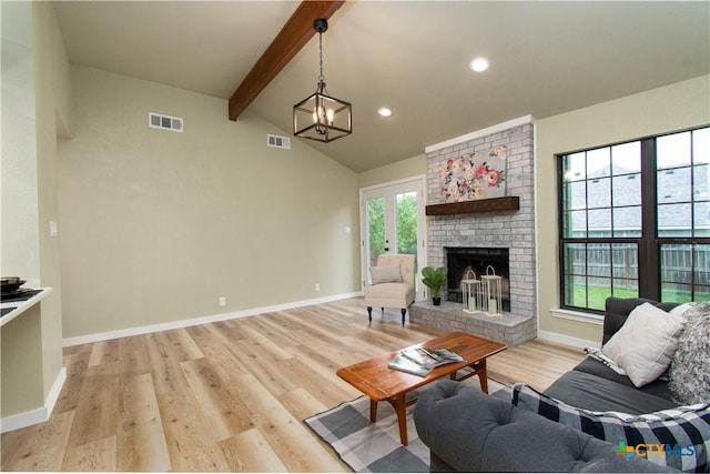 3918 Trinity Dr, Temple, TX 76504 - living room featuring light wood-style floors, a brick fireplace, baseboards, a chandelier, and recessed lighting