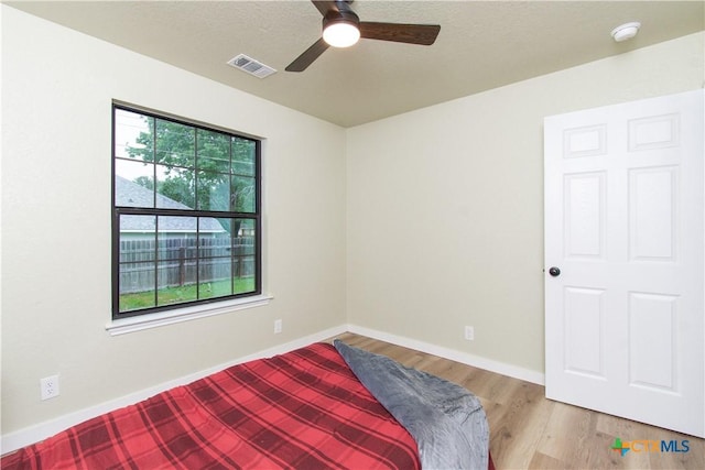 3918 Trinity Dr, Temple, TX 76504 - unfurnished bedroom featuring light wood-style floors, baseboards, and a ceiling fan