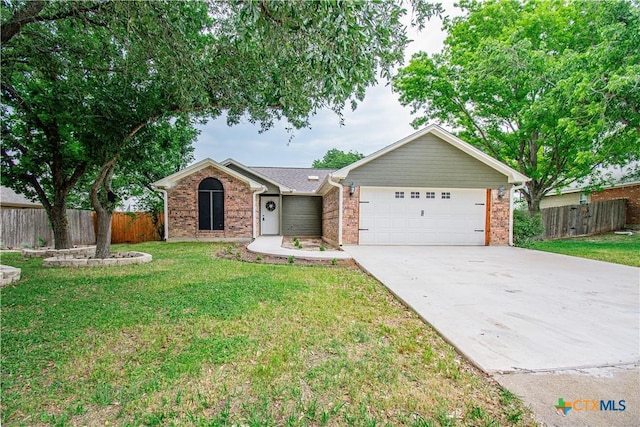 3918 Trinity Dr, Temple, TX 76504 - ranch-style home featuring a garage, driveway, and brick siding