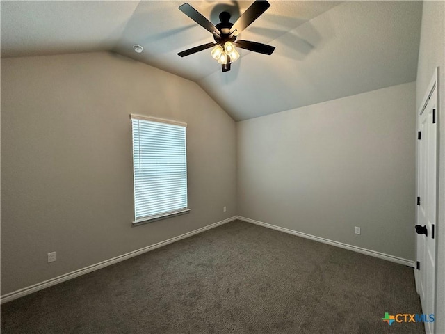 additional living space with ceiling fan, lofted ceiling, and dark carpet