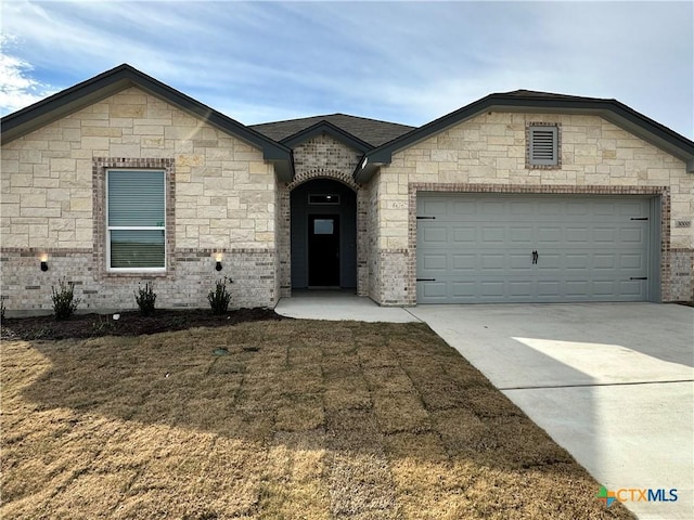 view of front of home with a garage and a front lawn