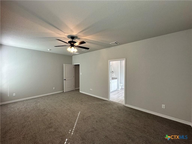 carpeted empty room with a textured ceiling and ceiling fan