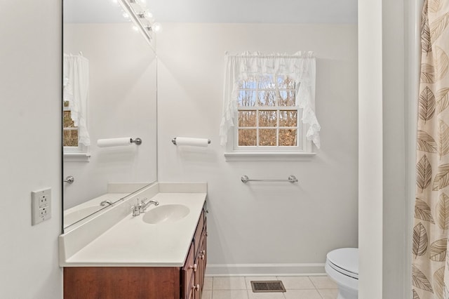 bathroom with tile patterned floors, vanity, and toilet