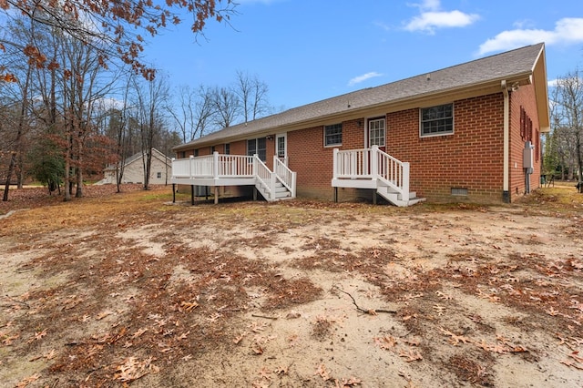 rear view of house with a wooden deck