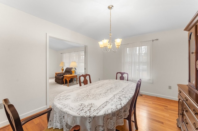 dining room featuring light hardwood / wood-style flooring and an inviting chandelier