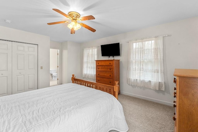 carpeted bedroom with ceiling fan and a closet