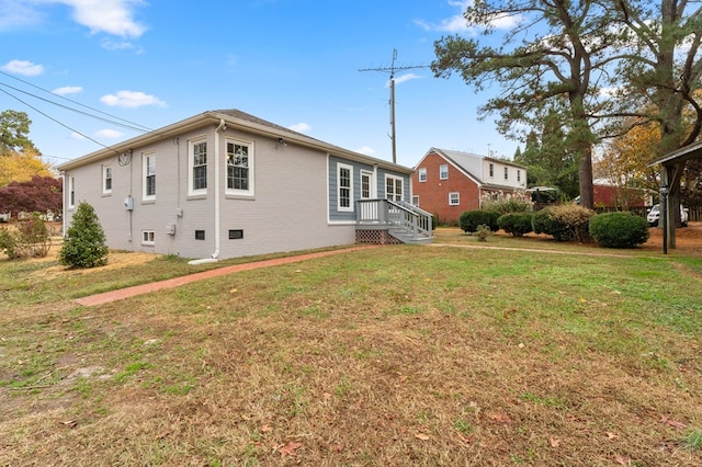 back of house with a lawn