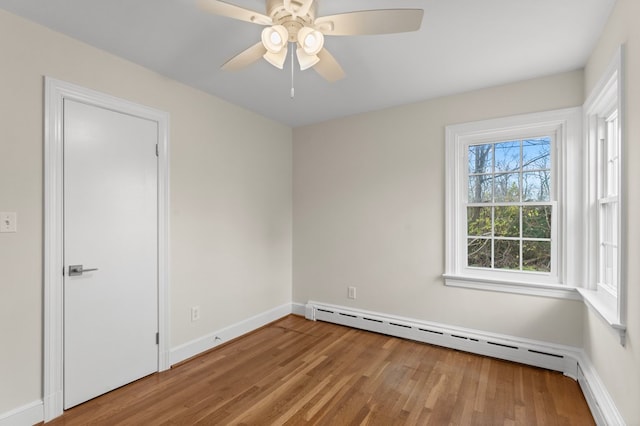 unfurnished room with a baseboard radiator, light hardwood / wood-style flooring, and ceiling fan