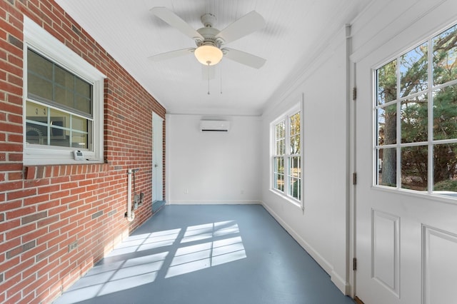 unfurnished sunroom with an AC wall unit and ceiling fan