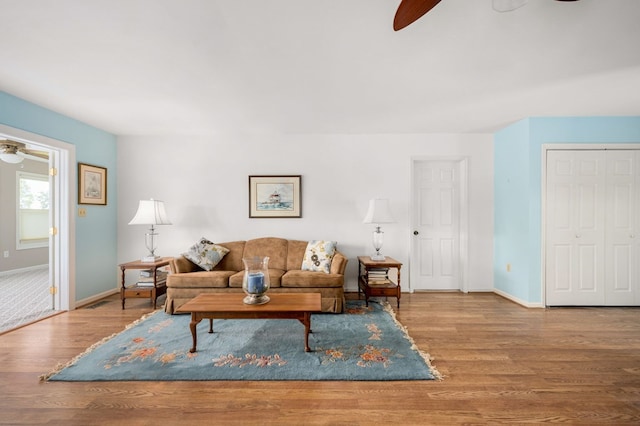 living room featuring hardwood / wood-style flooring and ceiling fan