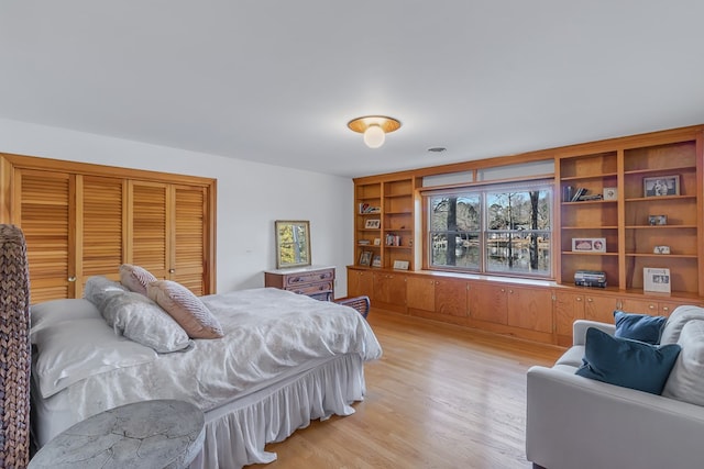 bedroom featuring a closet and light wood-type flooring