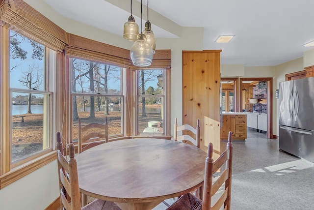 dining area featuring a water view