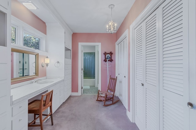 interior space with light carpet, an inviting chandelier, and sink