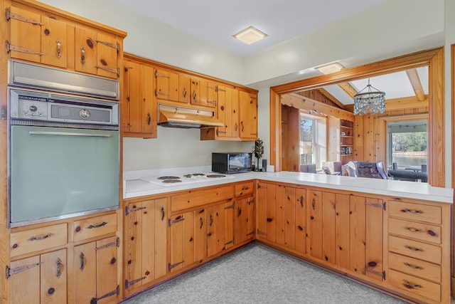 kitchen with a chandelier, black appliances, and lofted ceiling