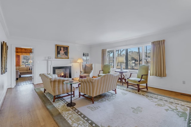 living room featuring hardwood / wood-style floors and ornamental molding