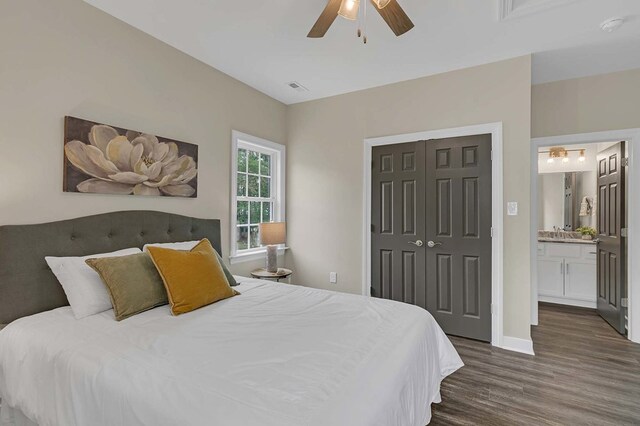 250 Pocahontas Ave, Deltaville, VA 23043 - bedroom with dark wood-type flooring, a closet, a ceiling fan, a sink, and connected bathroom