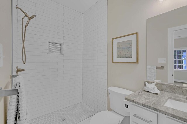 250 Pocahontas Ave, Deltaville, VA 23043 - bathroom with a tile shower, vanity, and toilet