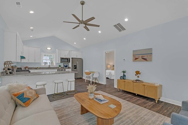 250 Pocahontas Ave, Deltaville, VA 23043 - living area with a ceiling fan, dark wood-type flooring, baseboards, recessed lighting, and high vaulted ceiling