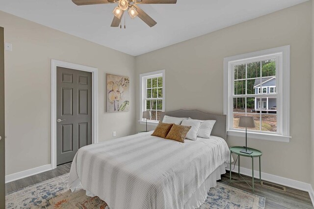 250 Pocahontas Ave, Deltaville, VA 23043 - bedroom featuring multiple windows, baseboards, and wood finished floors