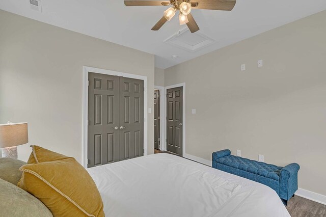 250 Pocahontas Ave, Deltaville, VA 23043 - bedroom with attic access, baseboards, wood finished floors, a closet, and ceiling fan