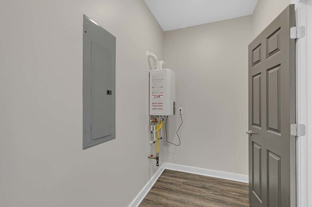 250 Pocahontas Ave, Deltaville, VA 23043 - laundry area featuring electric panel, baseboards, dark wood-type flooring, and water heater