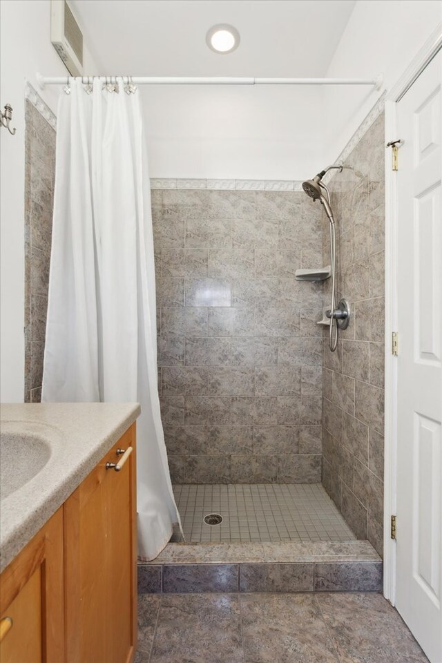 full bathroom with a stall shower and vanity