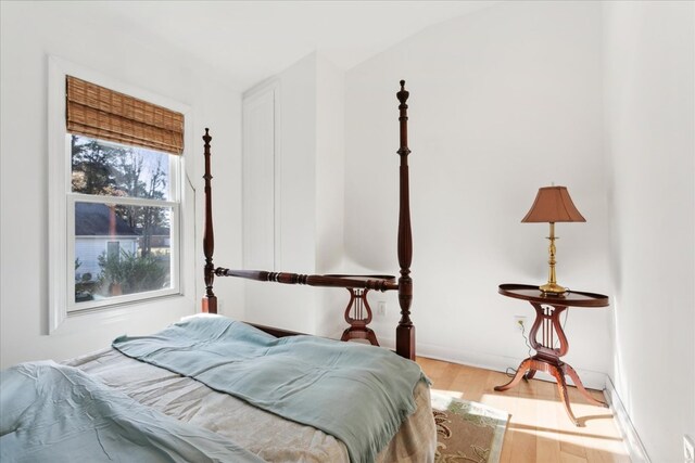 bedroom with baseboards and wood finished floors