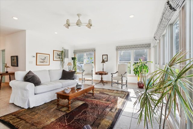 tiled living room with recessed lighting and baseboards