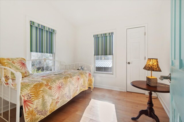 bedroom featuring baseboards and wood finished floors