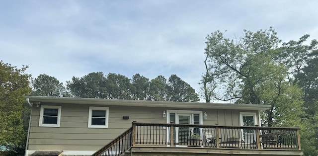 back of property featuring a wooden deck