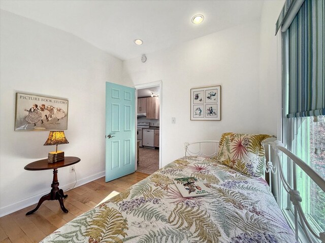 bedroom featuring recessed lighting, light wood-type flooring, and baseboards