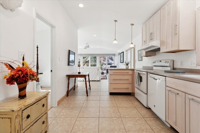 kitchen featuring under cabinet range hood, decorative light fixtures, white appliances, light tile patterned floors, and lofted ceiling