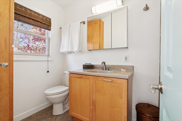 bathroom featuring tile patterned floors, toilet, and vanity