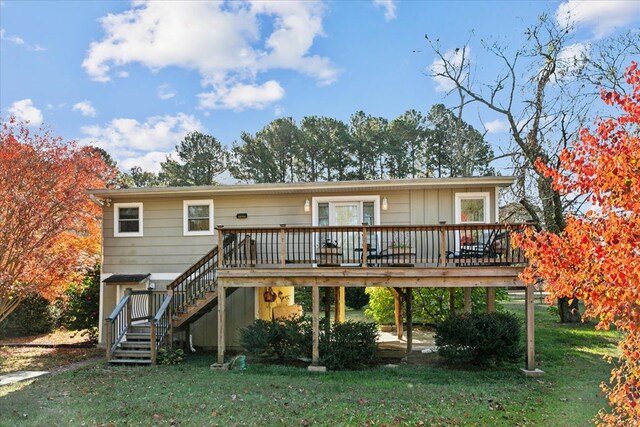 rear view of property featuring a patio area, stairway, a yard, and a deck