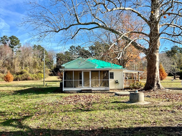 rear view of property featuring a lawn