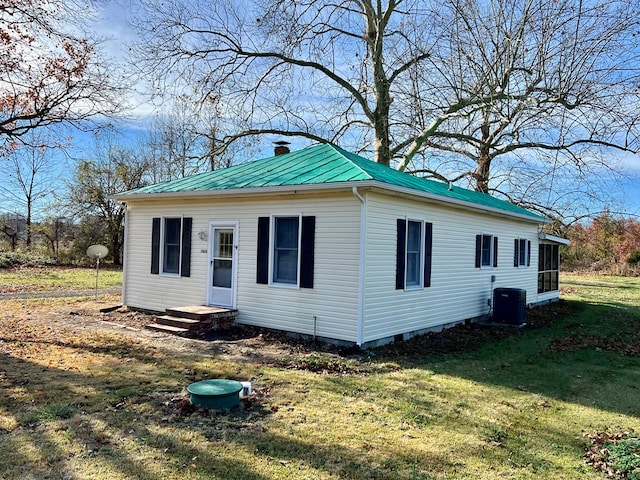 view of front of house featuring a front lawn and central AC unit