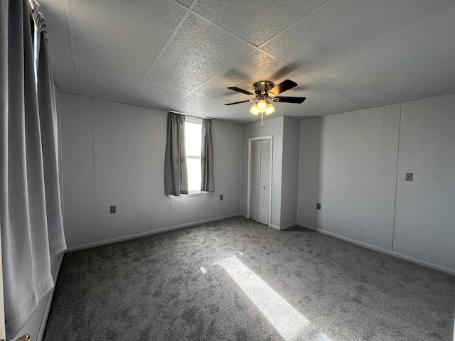 carpeted empty room featuring ceiling fan