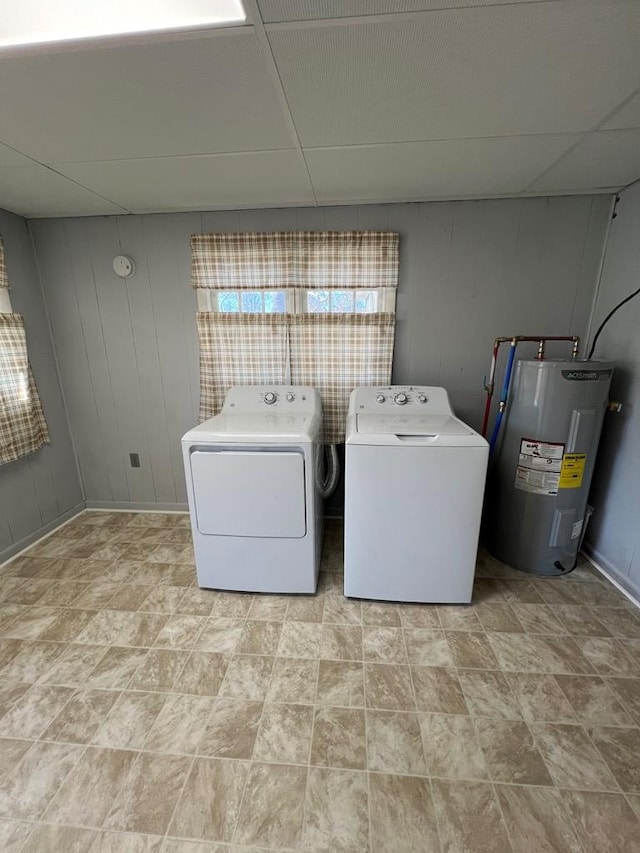 clothes washing area featuring washing machine and dryer and water heater